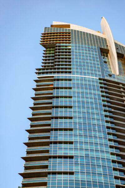 Glass skyscraper against blue sky, view from the bottom